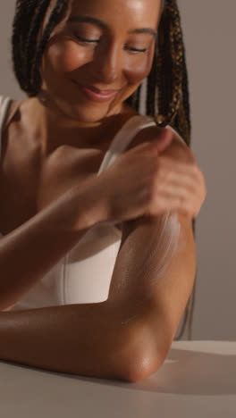 Studio-Skincare-Beauty-Shot-Of-Woman-Dispensing-Moisturiser-And-Pretending-To-Rub-It-Into-Camera-Lens-1